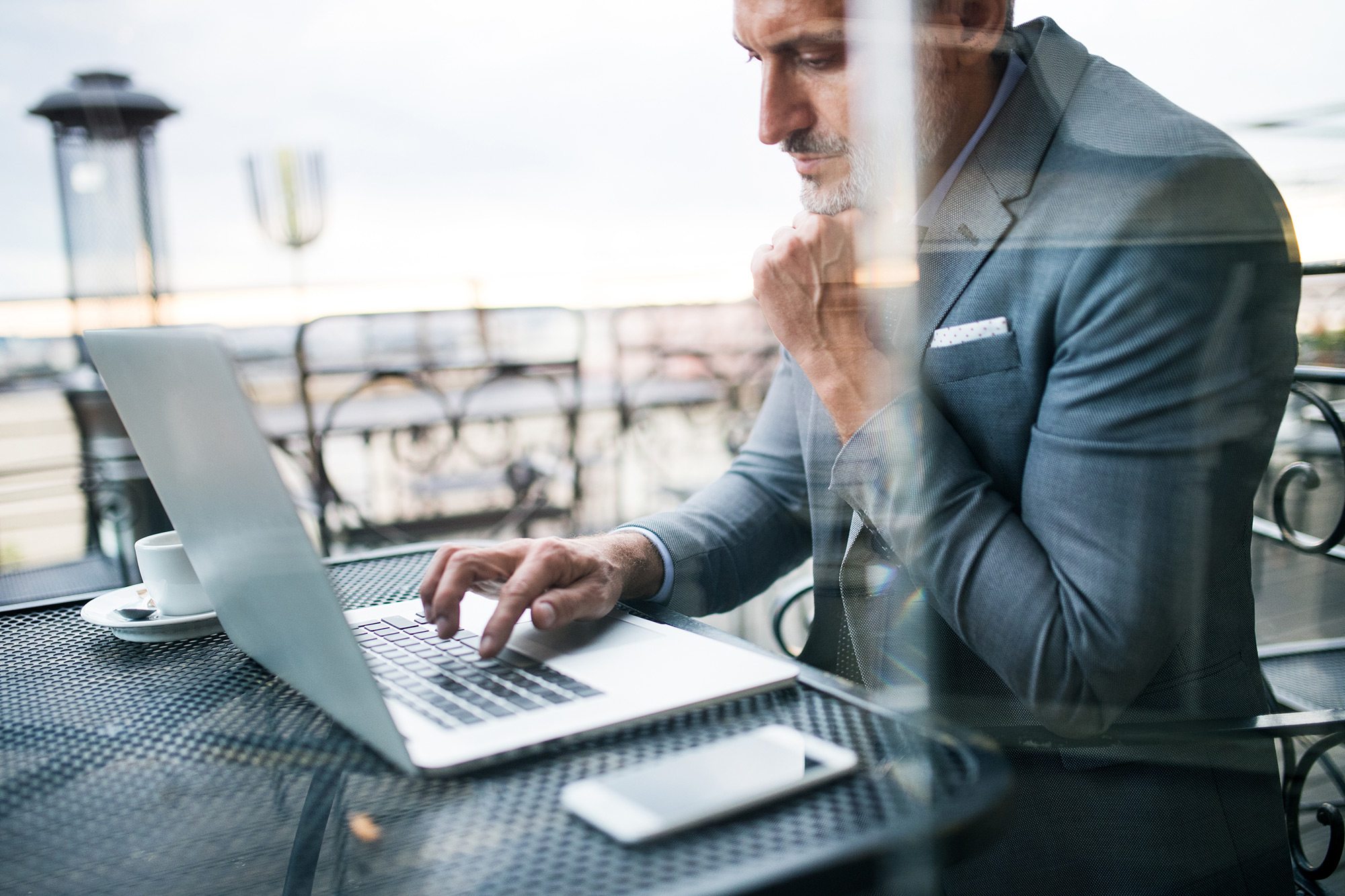 demo-attachment-33-Mature-businessman-with-laptop-outside-a-cafe.