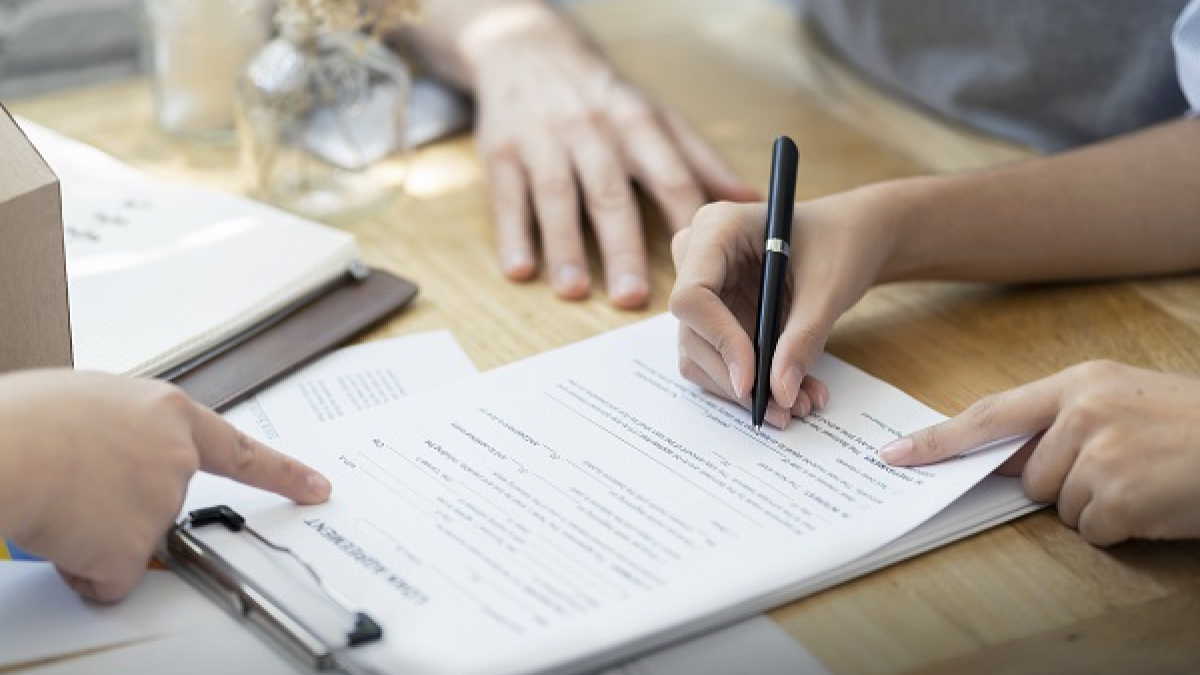 Woman putting signature on document loan contract, real estate p