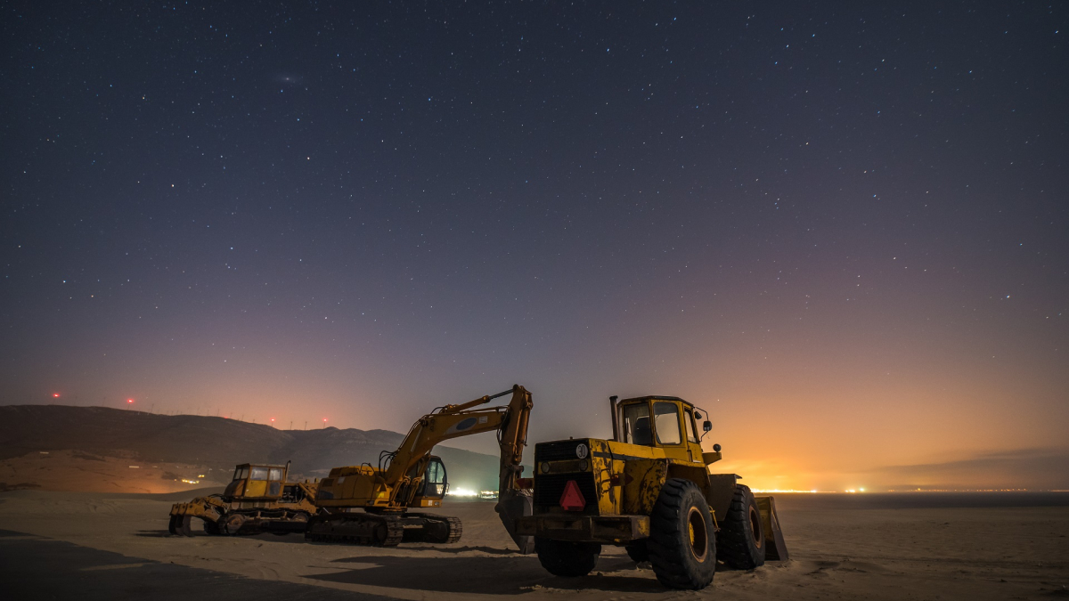 Working machines on a sand dune of the south of Spain at night