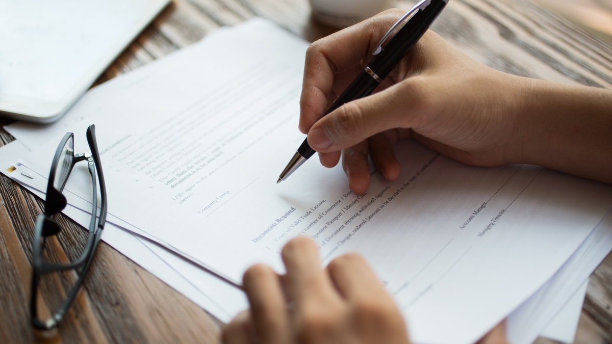 Businessman examining papers at table