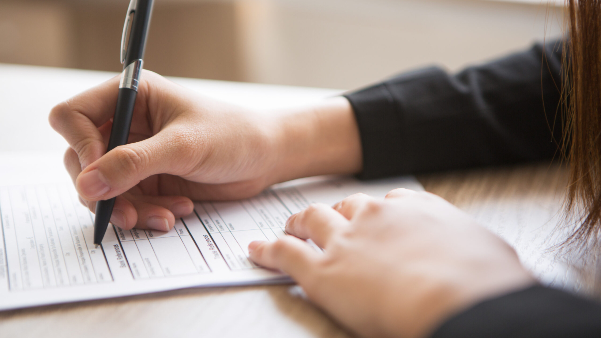 Cropped View of Woman Filling in Application Form